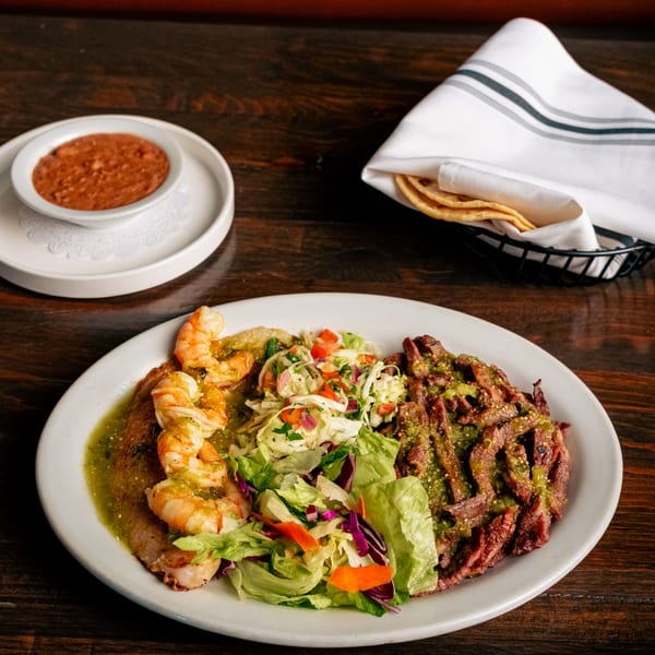 El Tarasco Restaurant Mooney's Mexican dish with shrimp, steak, salad, refried beans, and tortillas.