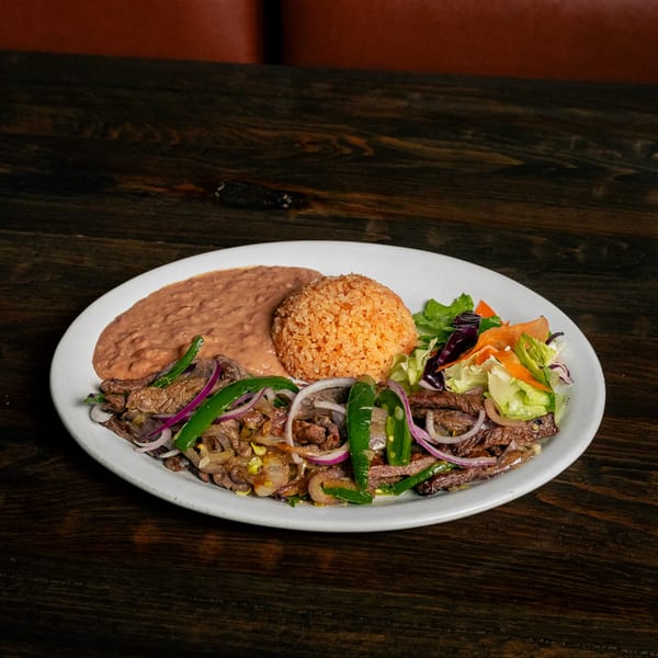 El Tarasco Restaurant Mooney's carne asada with rice, refried beans, and a side salad.